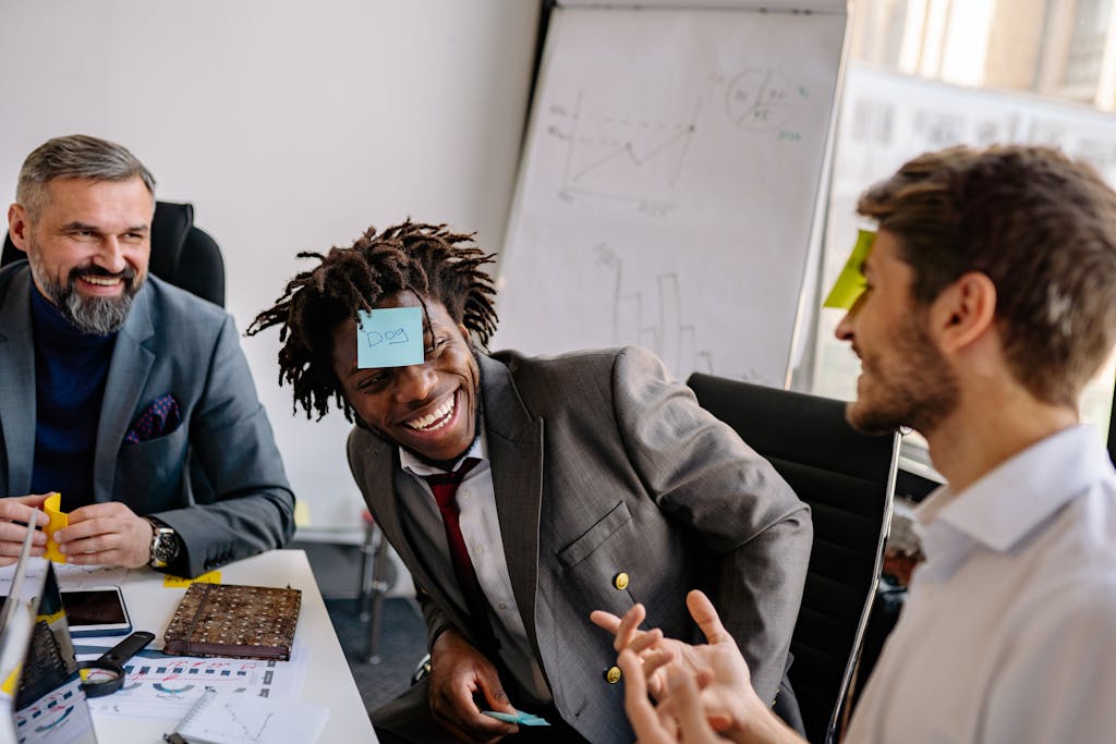 Three businessmen playing a lively game in the office, enjoying teamwork and laughter.